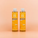 Photo publicitaire qualité studio, un lot de 2 flacons de huile nutritive beauté insolente présentés debout  sur un fond neutre couleur pêche claire.